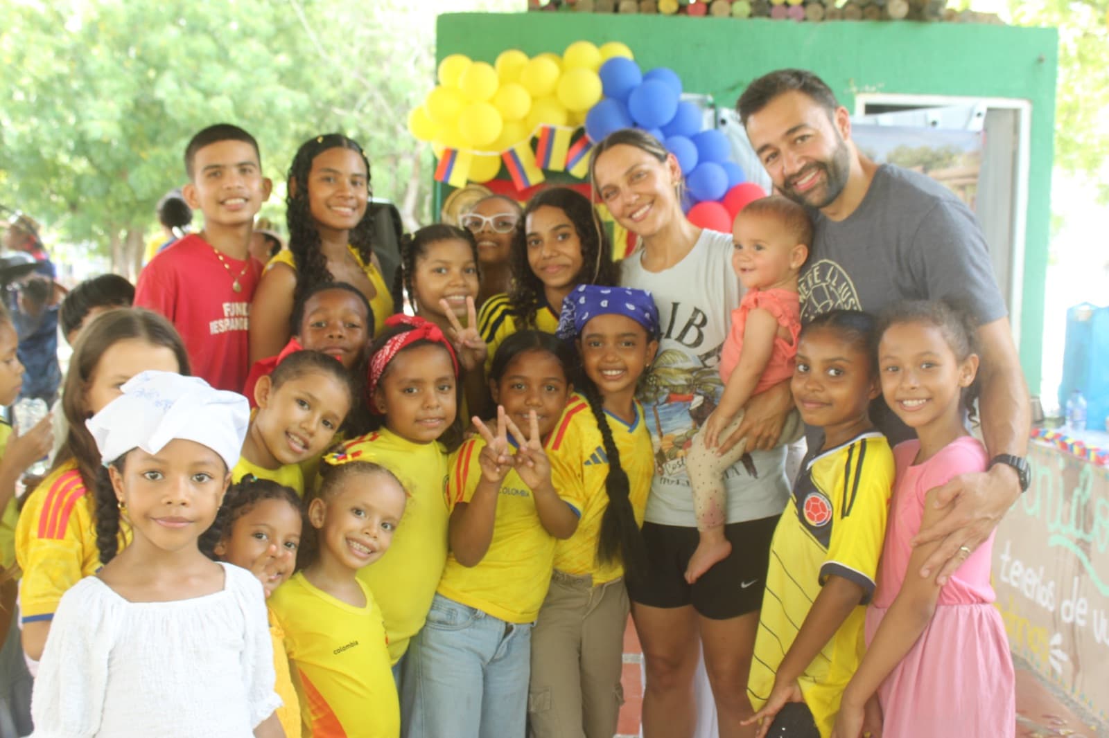 Volunteers and students posing together during the celebration