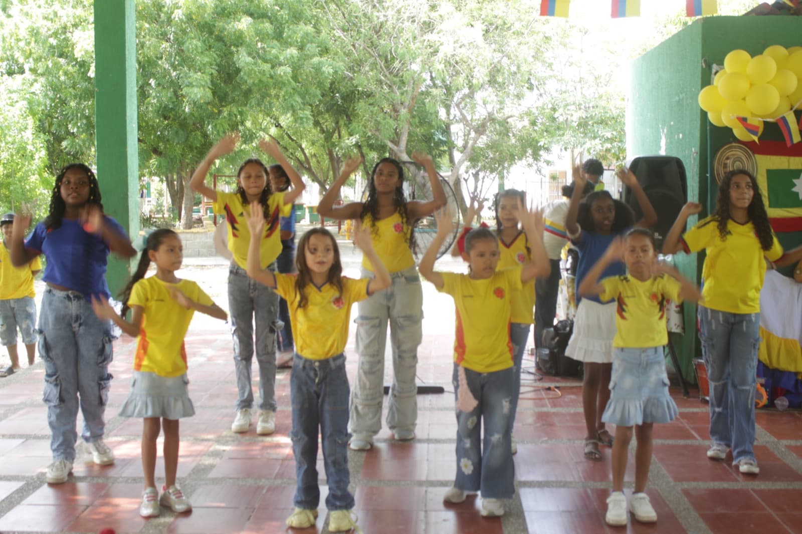 Girls performing a dance in the school courtyard