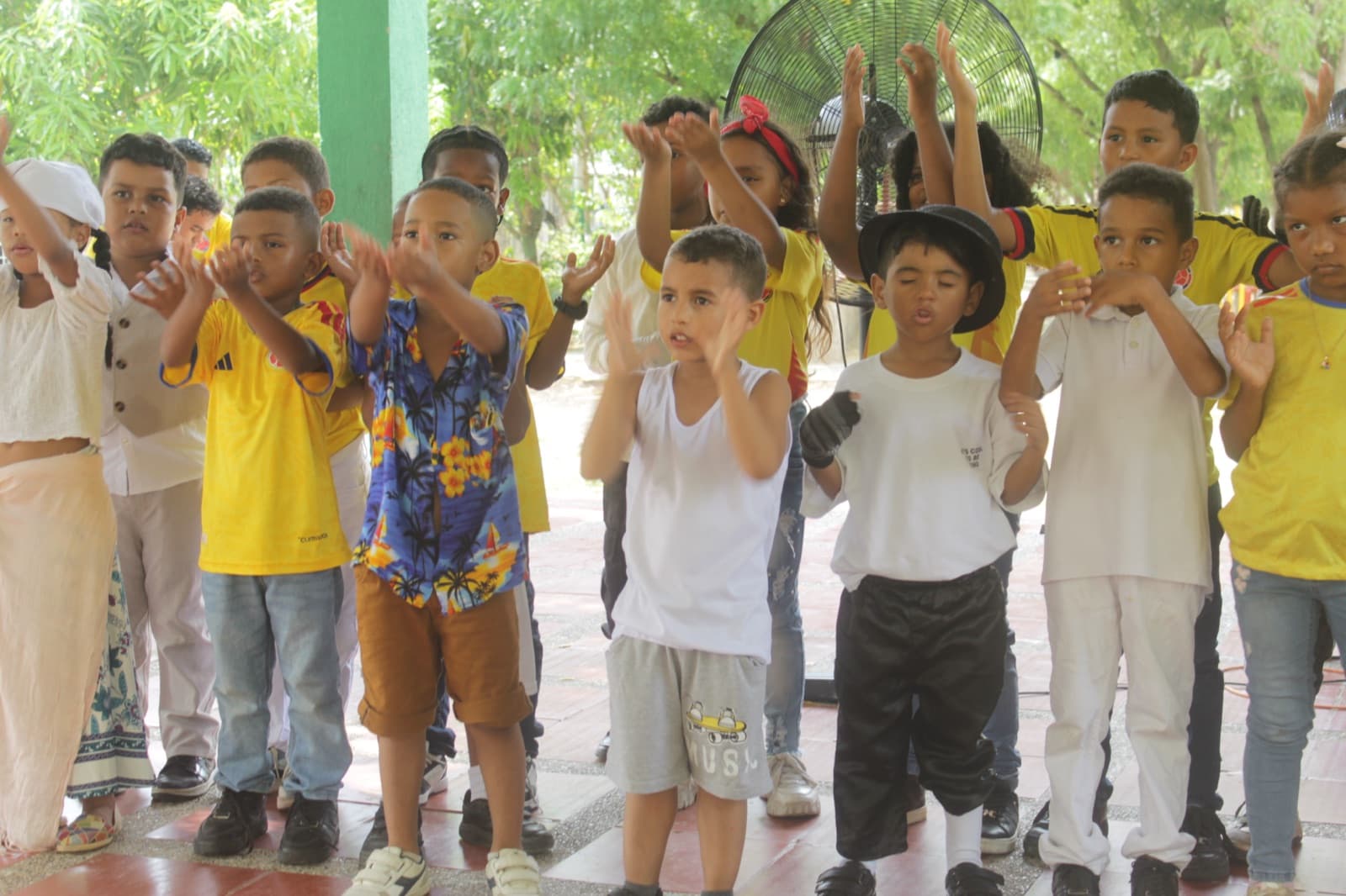 The younger students clapping along during the show