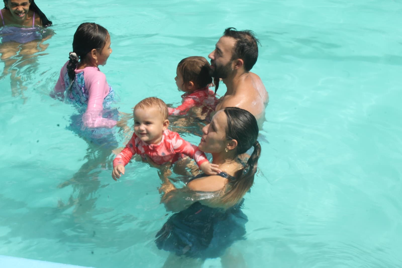 A family in the pool with the youngest children